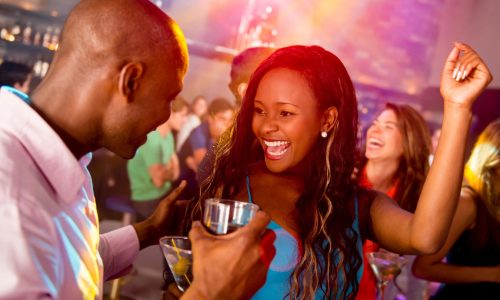 Happy couple clubbing at a nightclub having fun dancing